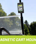 Swami Max Handheld Golf GPS Rangefinder With Oversized 3.5 Inch Color Screen on magnetic cart mount on golf course.