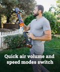 Person using Nitro Cordless Leaf Blower With 410 CFM Airflow And 130 MPH Turbo Power, Ultra Lightweight At 3.8 Lbs, in a garden setting