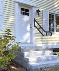 Heavy Duty U Shaped Handrails For Outdoor Steps Built From Solid Wrought Iron With Black Powder Coat Wall Mount Safety Grab Bars next to entrance.