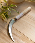 Saw-Tooth Blade Garden Sickle For No-Fuss Weeding And Harvesting Grass Weeds And Perennials, Durable Lightweight Hand Weeder Knife For Tough Stems Vines And Brush, Easy Cut Made In Japan on wooden table