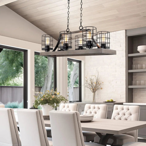 Farmhouse Dope 6 Light Kitchen Island Light with Cage Style Shades hangs over dining table, weathered ash wood finish and black accents