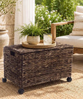 Large Rolling Wicker Storage Basket Made From Water Hyacinth, 15.5 Gallon Chest with Smooth Rolling Wheels on a patio