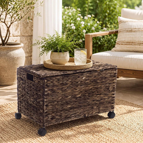 Large Rolling Wicker Storage Basket Made From Water Hyacinth, 15.5 Gallon Chest with Smooth Rolling Wheels on a patio