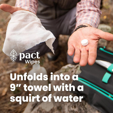 Person holding compressible wipe and pellet from Lite Bathroom Kit For Camping And Backpacking Ultralight Backcountry Gear.