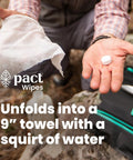 Person holding a compressed towel tab next to a 9-inch towel in nature, part of the Ultra Lite Outdoor Bathroom Kit for Hiking, Trail Running, Mountain Biking, and Bikepacking Ultralight Waste Disposal System Weighs 2.1oz Holds Three Bathroom Trips Perfect for Backcountry Camping and Fishing.