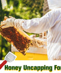 Beekeeping Honey Uncapping Fork With 18 Stainless Steel Tines And Plastic Handle shown with beekeeper holding honey frame
