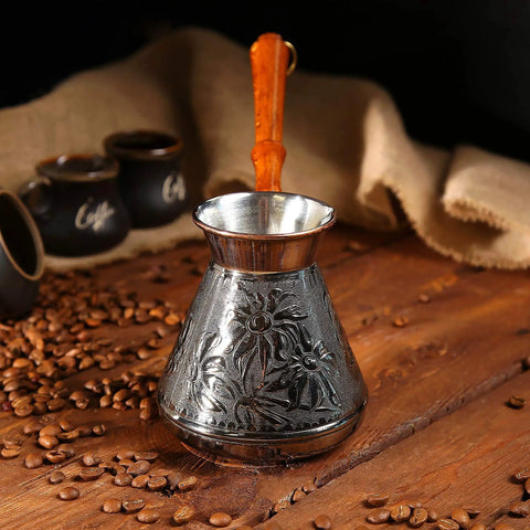 Copper Turkish Greek Arabic Engraved Coffee Pot For Go-To Stovetop Brew With Wooden Handle Cezve Ibrik Briki on wooden table.