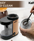 Premium Electric Flat Burr Coffee Grinder Featuring Adjustable Burrs And An Upgraded Quiet Motor For Legit Home Brewers 55 Ounce Copper Hopper being cleaned.