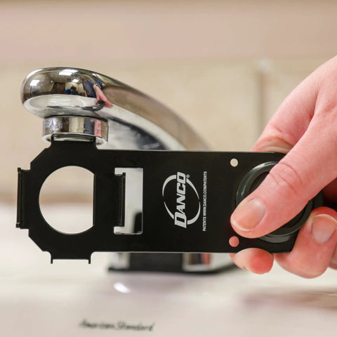 Hand using Easy Peasy Multi Use Faucet Aerator Key Tool For Scratch Free Removal And Installation Fits Most Standard Nickel And Tiny Aerators Works On Most Brands Durable Black Handle on faucet