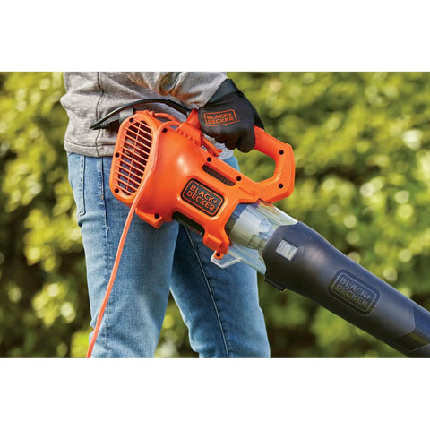Person using Corded Handheld Leaf Blower With 450 CFM And 140 MPH Power, Lightweight Axial Design For Quick Yard Cleanup in garden