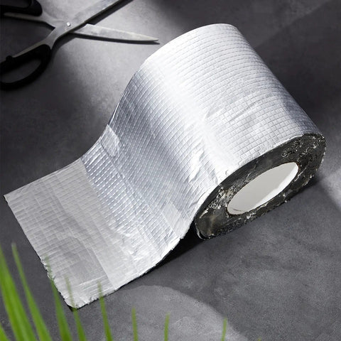 Six Inches By Thirty Three Feet Peel And Stick Roofing Roll With Strong Bond Rubber Adhesive and Sun Shield Aluminum Top view on a dark surface.
