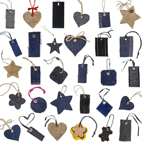 Various shapes of denim and burlap tags with strings and grommets for DIY crafts and projects displayed on a white background.