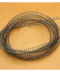 Two Pack Heavy Duty Thin Long Compression Springs In Steel, 1.5mm Wire Diameter, coiled on a tan surface