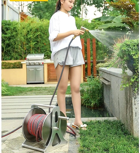 User watering plants with Top Notch Stainless Steel Hose Reel With Wall Mount Heavy Duty 40M Water Coil Rack And High Pressure Spray Gun For Garage Backyard Grind And Weekend Projects Built To Last.
