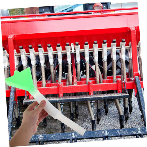 Hand holding Pro Grade Precision Seeder Tube Kit for Seed Drill Gear showing seed distribution tubes and red planter attachment.