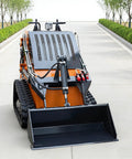 Front view of tracked mini skid steer loader with backhoe attachment for infrastructure construction and dock loading on urban streets
