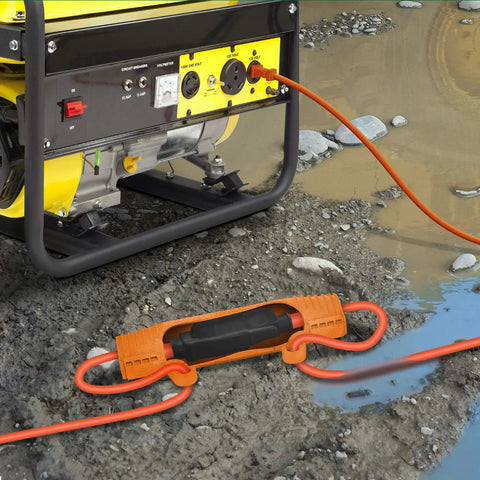 Bright orange Heavy Duty Outdoor Extension Cord Safety Cover and Weatherproof Connector Protector in muddy outdoor setting