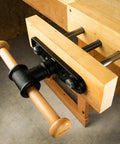 Close-up of Nine Inch Quick Release Workbench Front Vise With Heavy Duty Cast Iron Body featuring wooden handle and clamping mechanism.