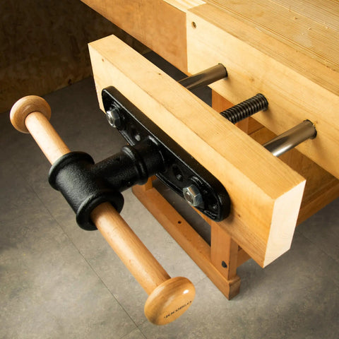 Close-up of Nine Inch Quick Release Workbench Front Vise With Heavy Duty Cast Iron Body featuring wooden handle and clamping mechanism.