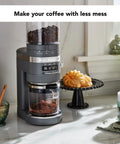 Premium Burr Coffee Grinder With Smart Dosing Technology For Dead Simple French Press To Espresso Ground Settings In Smooth Charcoal Grey Design near coffee and snacks.