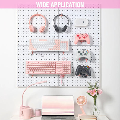Pink Pegboard Hooks 2 Inch Set With Rubber Safety Tips used for organizing keyboards, headphones, and controllers on a pegboard
