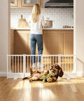 Built Tough No Drill Small Dog Gate 48 Inch Foldable Puppy Barrier For Home Doorways, white metal gate with cocker spaniel in kitchen.