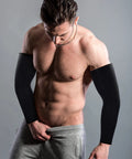 Man wearing black Unisex UV Protection Arm Sleeves Set 12 Pairs Long Cooling Cover For Outdoor Adventures, showing wrist to elbow coverage.