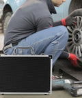 Portable Aluminum Toolbox With Lock Sleek Rigid Case For Small Tools Hardware Gear beside mechanic changing tire.