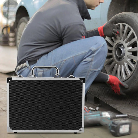 Portable Aluminum Toolbox With Lock Sleek Rigid Case For Small Tools Hardware Gear beside mechanic changing tire.