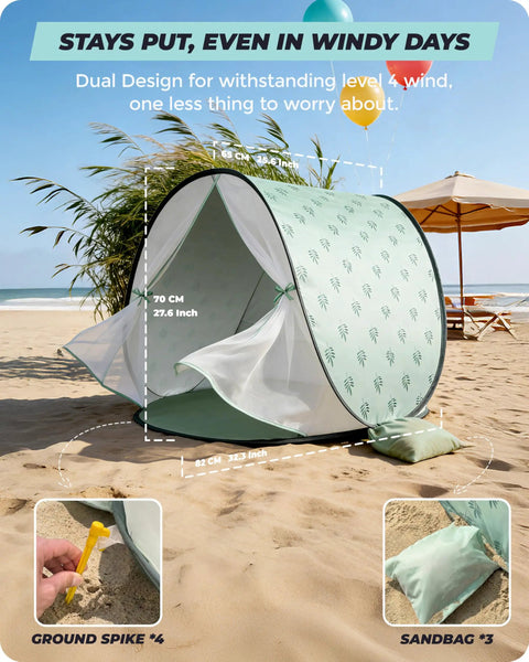 Pop Up Baby Beach Tent With UPF 50+ Sun Shade Mosquito Net Shelter Portable Outdoor Canopy For Babies And Toddlers Green Leaves Pattern on sandy beach.