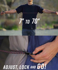 Person demonstrating 7 to 70 inch Heavy Duty Adjustable Bungee Cords With Hook And Carabiner, showing stretch and quick adjust hooks
