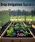 Effortless 100 Foot Drip Irrigation System Kit With 30 Adjustable Nozzles in a raised garden bed setup