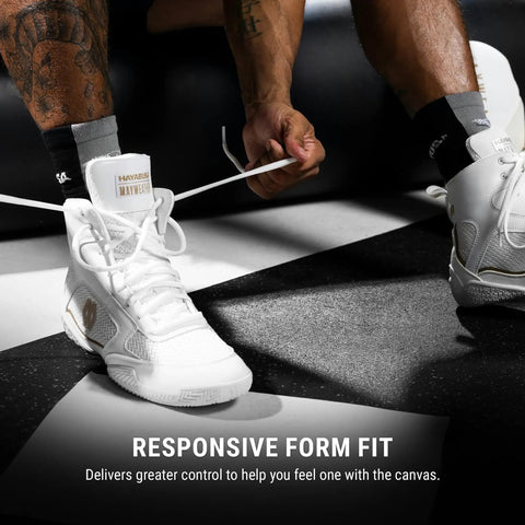 Person tying laces on Mayweather Champ Boxing Shoes For Men And Women Unisex White Gold Mid Height Traction And Stability For Training