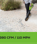 Person using 40V Cordless Walkway Warrior Yard Tool Combo Kit With 2.0Ah Battery And Charger Trimmer With 12 Inch Auto Feed Line And 390 CFM Leaf Blower to clear debris on pathway