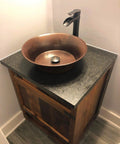 Bathroom setup with Copernicus Handmade Vessel Sink In Pure Solid Copper, 16 Inch, Aged Copper Finish on wood cabinet.