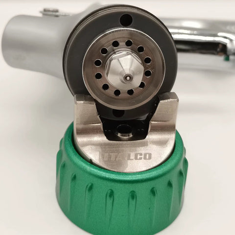 Close-up of Italian Designed HVLP Spray Gun With 1.3mm Tip And 600ml Cup Ergonomic Palm Fit Handle showing nozzle and green cap.