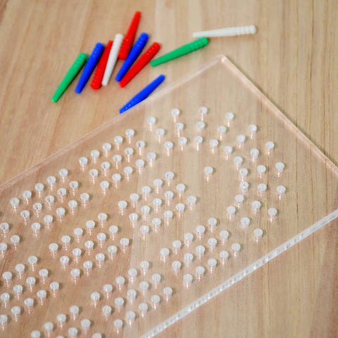Clear Acrylic Cribbage Board Template Kit With Twelve Colorful Counting Pegs For Game Night Essentials showing pegs and drilled holes.