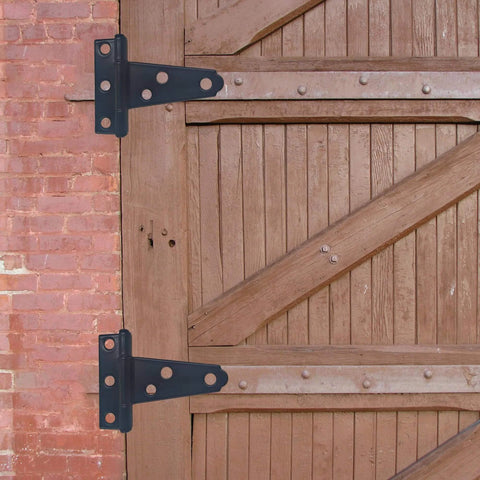 Wooden barn door with 6-Pack Heavy Duty 2 Inch T-Strap Hinges In Black Rustic Iron for outdoor sheds and fences.