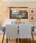 Dining room with three pack indoor mini pendant lights for kitchen island in polished nickel with hand blown orange glass shades