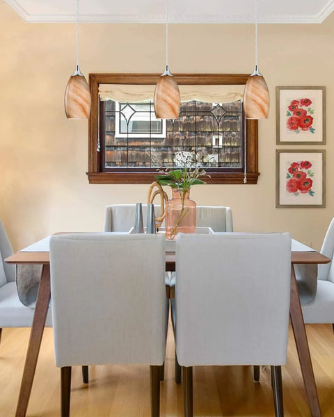 Dining room with three pack indoor mini pendant lights for kitchen island in polished nickel with hand blown orange glass shades