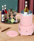 Electric Coffee Mug Warmer And Ice Cold Chiller With Dual Mode Temp Control Aluminum Desktop Heated Coaster USB Powered Drink Stand Keep Your Sip Fresh For The Daily Grind Pink on a wooden table with drinks.