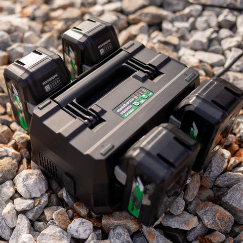 4-Port Battery Charger For 18V And 36V Slide-Style Batteries With Rapid Charging, on rocky surface