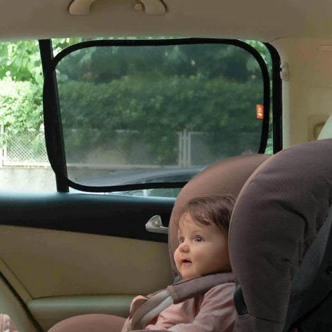 Child in car seat next to installed 2 Pack Car Window Sun Shades For Kids, UPF 50+ UV Block, 14.2 By 21.3 Inches, Static Cling Privacy Covers