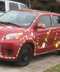 Red car decorated with colorful polka dots inspired by 63 White Polka Dot Wall Decals For Kids Rooms And Nurseries. Easy DIY decor.