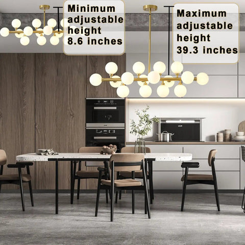 Kitchen interior with two gold pendant lights, minimum 8.6 inches, maximum 39.3 inches, above dining table and modern chairs.