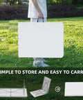 Person carrying Six Foot Folding Table For Indoor And Outdoor Use Your Go To Portable Plastic Dining Table With Carrying Handle