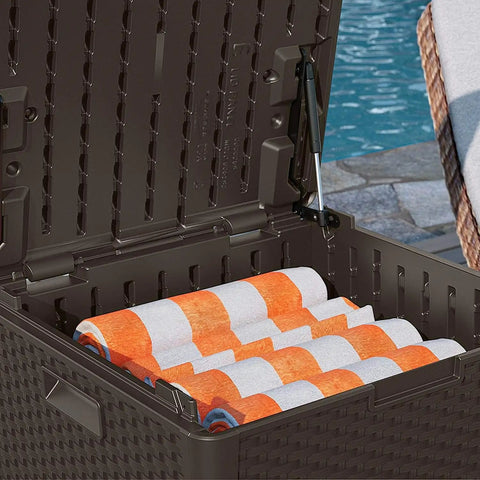 60 Gallon Outdoor Storage Box in Java Resin, open with towels inside, wicker-style, next to pool, made in USA