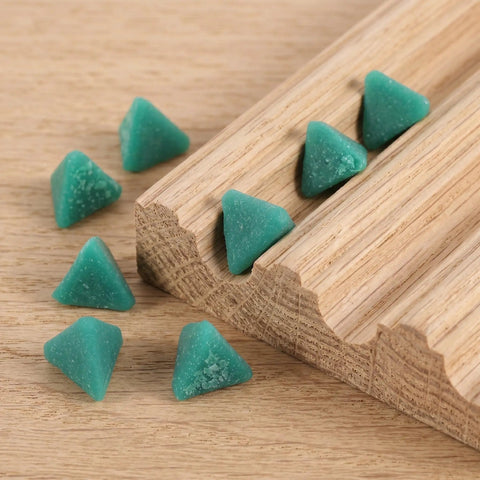 Three Usable Sides Triangular Resin Polishing Media Blocks for Metal Tumbling Machines displayed on wooden surface