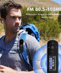 Man hiking with 64GB USB MP3 Player With Bluetooth 5 3 Clip Jam attached to backpack strap, mountain trail background