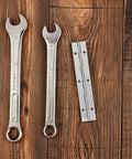 Heavy Duty Piano Hinge for Overlay Cabinet Doors and Furniture, Smooth pivot, alongside two wrenches on wooden surface
